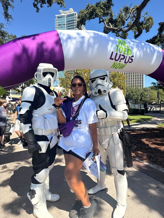 Dr. Cece with two Stormtroopers under the walk arch